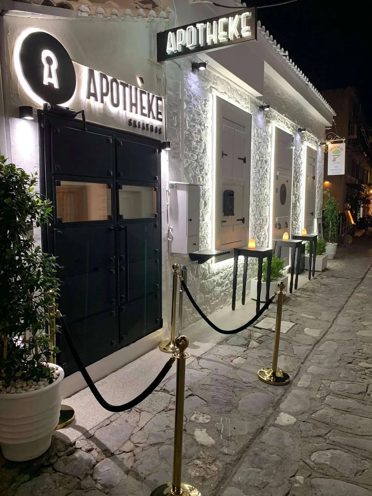 Η είσοδος της Αποθήκης τη νύχτα, κάτω από τη φωτεινή πινακίδα